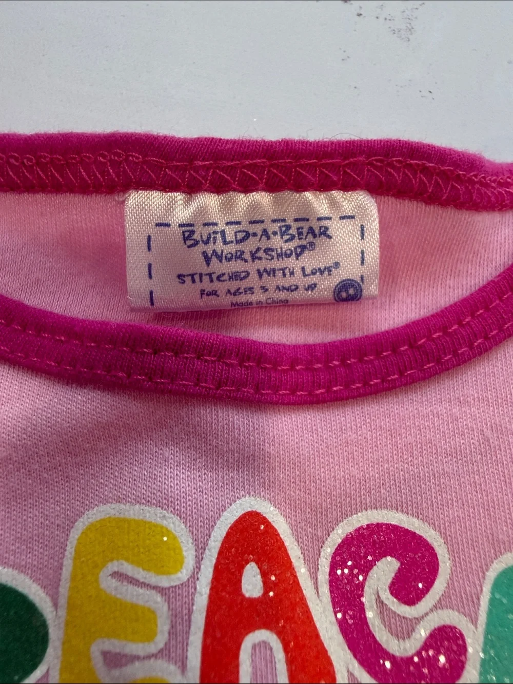 Build-a-bear pink peace sign shirt